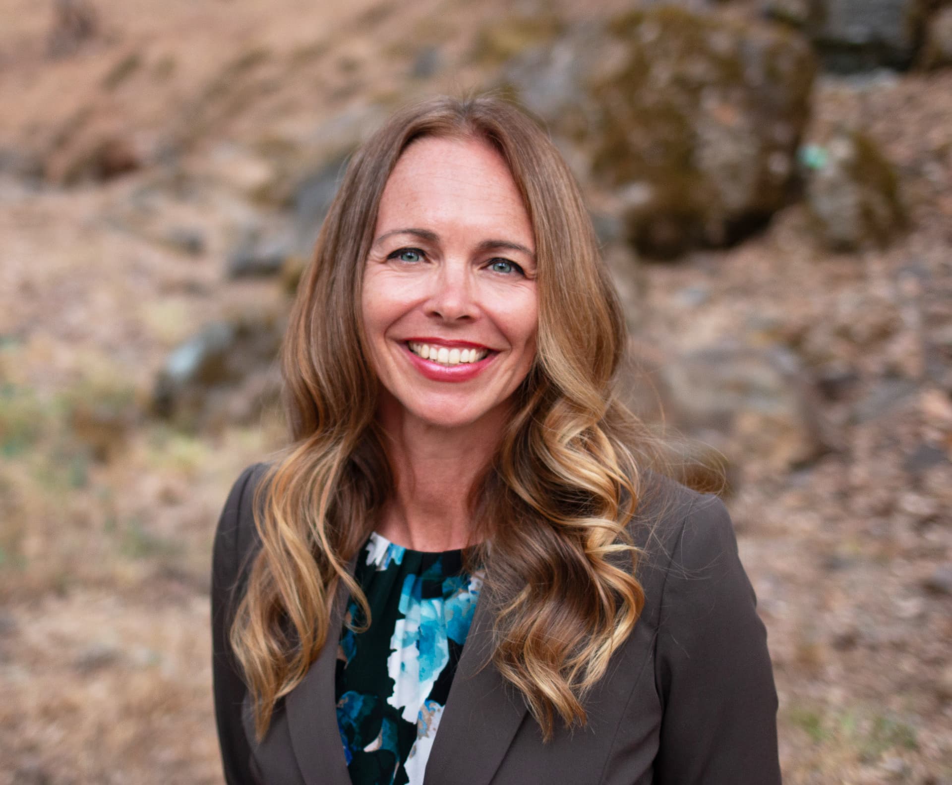Dr. Laura Truxler smiling in a brown blazer